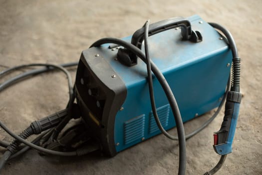 Electricity generator. Tools in garage. Battery storage. Charging wires.