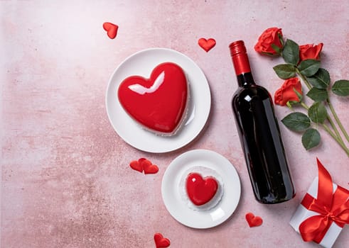 Valentines day. heart shaped glazed valentine cake, gift and wine on pink concrete background