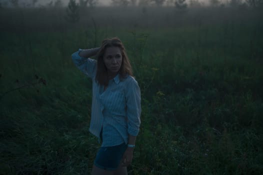 Woman in a field with misty fog