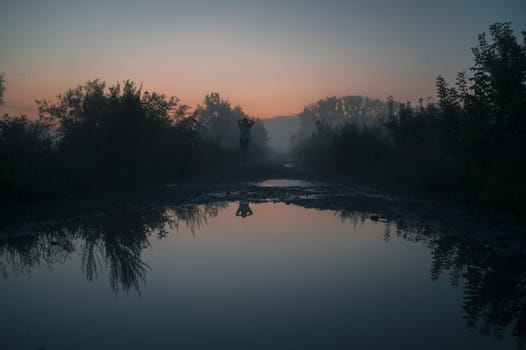 Woman in beautiful misty fog, summer landscape