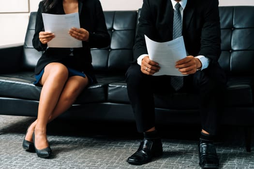 Stressed businessman and businesswoman candidate sit and wait for interview at the company office. Job application, business recruitment and Asian labor hiring concept. uds