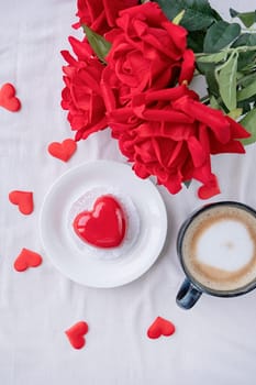 Valentines day. heart shaped glazed valentine cake and flowers in bed