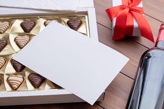 Valentines day. valentine sweet chocolate and red wine on wooden background