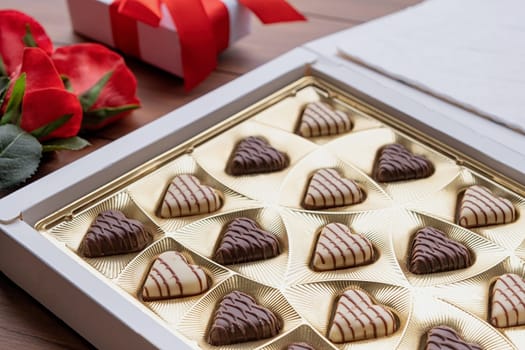 Valentines day. valentine sweet chocolate and red wine on wooden background