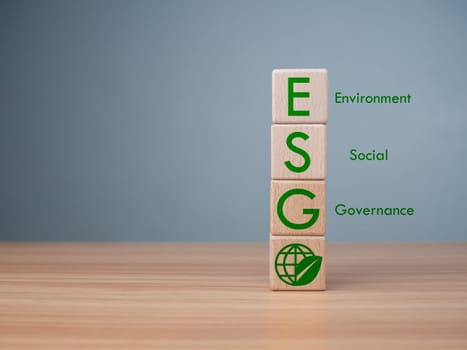 ESG concept of environmental, social and governance, wood block and icon on wooden background It is an idea for sustainable organizational development ​account the green environment.