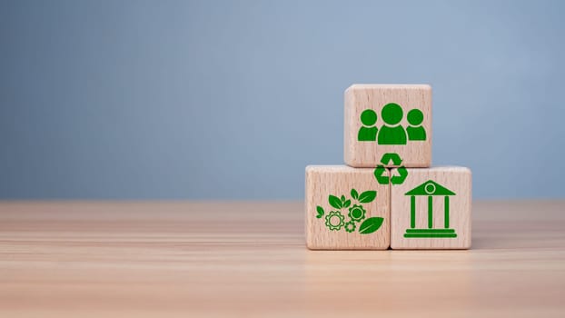 ESG concept of environmental, social and governance, wood block and icon on wooden background It is an idea for sustainable organizational development ​account the green environment.