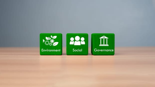 ESG concept of environmental, social and governance, wood block and icon on wooden background It is an idea for sustainable organizational development ​account the green environment.