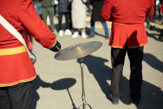 Drummer at parade in red clothes. Drumming. Percussion musical instrument.