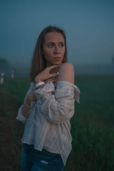 Woman in a field with misty fog