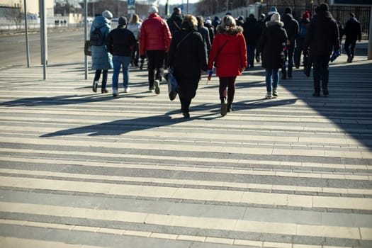 Lot of people cross road. City during rush hour. Pedestrians cross highway. Urbanity life.