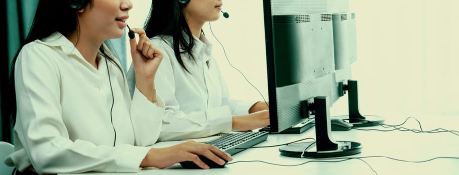 Business people wearing headset working in office to support remote customer or colleague. Call center, telemarketing, customer support agent provide service on telephone video conference oratory call