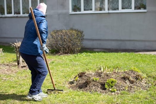 Woman makes flower bed. Gardener is working. Creating beautiful garden. Work in fresh air. Summer landscaping of yard.