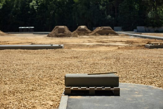 Construction site. Construction of parking in city. Embankment for asphalt. Construction details.