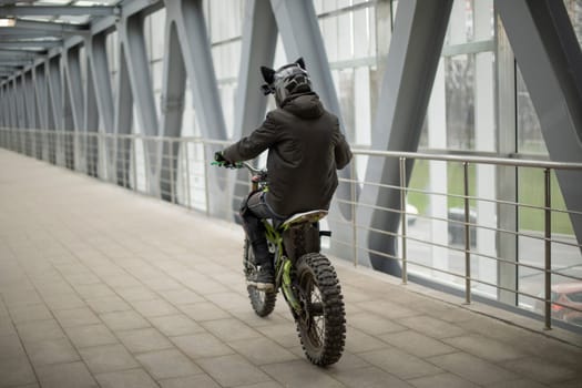 Motorcyclist rides through pedestrian tunnel. Violation of rules of riding bike. Extreme rides. Extreme driving in city.