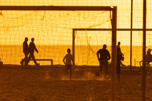 A group of people playing a game of soccer