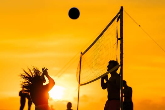 A group of people playing a game of volleyball