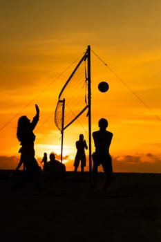 A group of people playing a game of volleyball