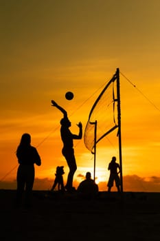 A group of people playing a game of volleyball