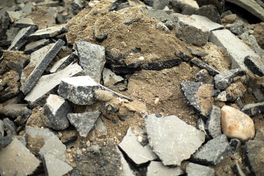 Lots of stone. Construction waste. Details of broken road.