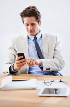 Businessman, phone and networking or texting in office, connection and contact for company. Male person, professional and communication or mobile application, technology and smile for discussion.