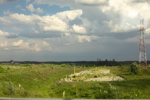 Communication tower in field. Details of radio infrastructure. Signal transmission antenna.