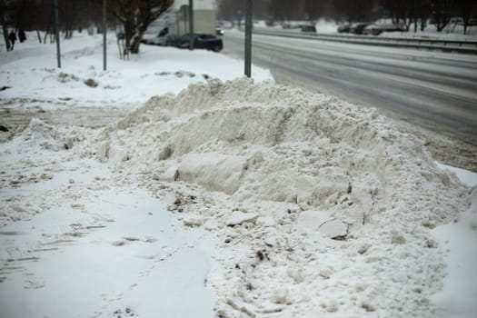 Snow on side of road. Snow removed from track. Details of road in winter.