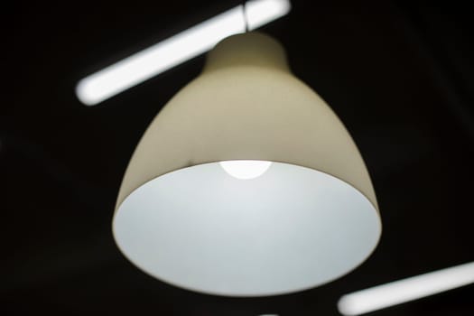 Lamp in interior. Light in room. Lamp on ceiling. White light.
