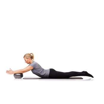 Woman, exercise ball and stretching on yoga mat or workout performance, pilates wellness or white background. Female person, gym equipment and fitness in studio for mockup space, challenge or balance.