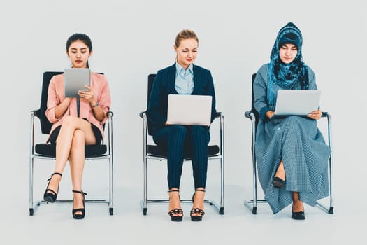 Business people job applicants sitting and waiting on chairs in office. Job application and recruitment concept. uds