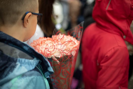 Festive bouquet. Flowers in child. Teaching brings flowers to teacher. Details of holiday.