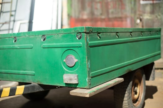 Trailer for car. Cart for cargo transportation. Transport details. Green trailer.