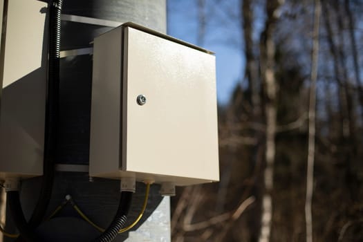 Box of wires. Electrical equipment on pole. Electricity switch.