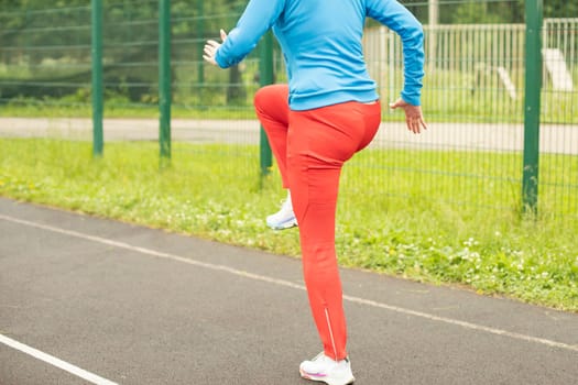 Playing sports on street. Outdoor training. Woman burns calories.