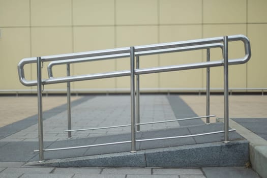 Steel handrail for few mobile people. Architecture details. Lift for stroller. Comfortable urban environment.