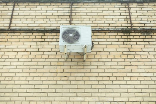 Air conditioning on wall. Air cooling system. Grille and fan.