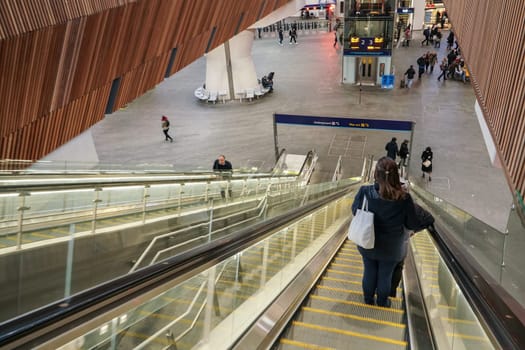 London, United Kingdom - February 01, 2019: Going down the escalators, some passengers in front and on lower floor, at London Bridge station. It is fourth busiest in UK capital.