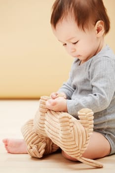 Baby, stuffed animal and playing in home for comfort care, childhood development or game entertainment. Kid, toy teddy and learning in apartment for education progress, coordination, growth or youth.