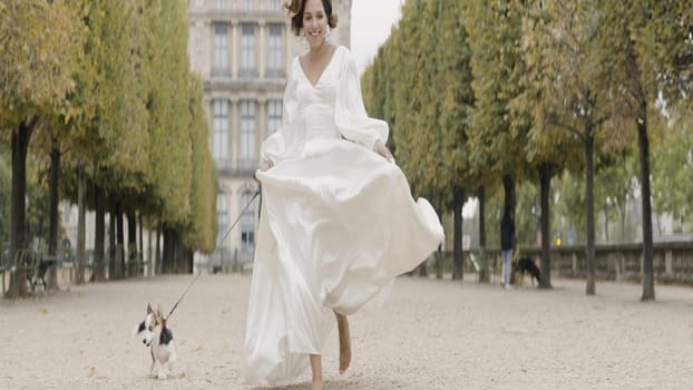 Wedding photography with your favorite pet. Action. A beautiful model running with a dog and sitting with her husband walking her companion. High quality 4k footage