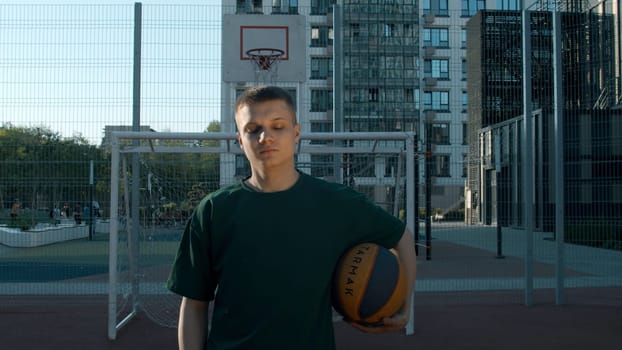 A handsome male athlete. Media. A man standing on a volleyball court with a ball. High quality 4k footage