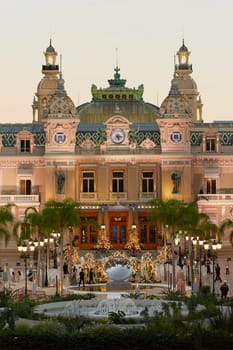 Monaco, Monte-Carlo, 21 October 2022: Square Casino Monte-Carlo at sunny day, a lot of luxury cars, Hotel de Paris, wealth life, tourists take pictures of the landmark, pine trees, blue sky, flowers. High quality 4k footage