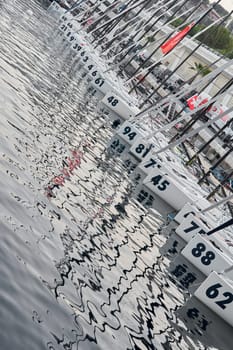 Monaco, Monte-Carlo, 18 October 2022: A lot of sailing boats are moored in new Yacht Club at the world championship of J70 class at sunset, port Hercules. High quality photo