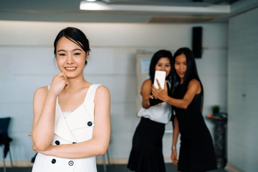 Young Asian businesswomen standing in office. Business friends and community concept. uds
