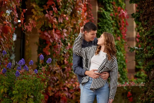 Young Cute Female Hugs Boyfriend. In Autumn Outdoor. Lovers Walking in Park. Attractive Funny Couple. Lovestory in Forest. Man and Woman. Cute Lovers in the Park. Family Concept. Happy Couple.