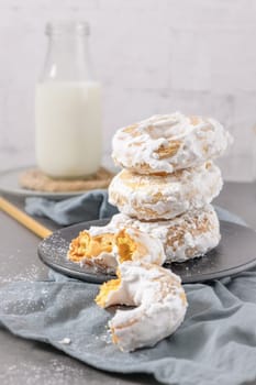 Sweet portuguese donuts with white glaze. Donuts baked at home. Simple and tasty dessert.