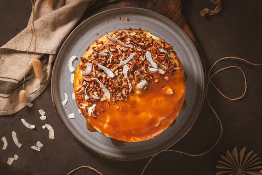 Delicious caramel cake with small pieces of pecan nuts and coconut shavings.