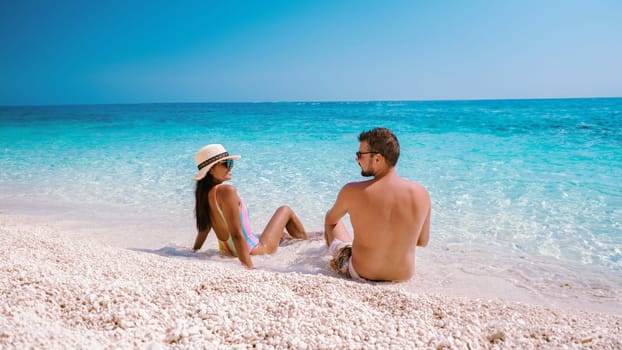 Golfo di Orosei Sardina a man and women on the beach in Sardinia Italy, a young couple on vacation in Sardinia Italy,