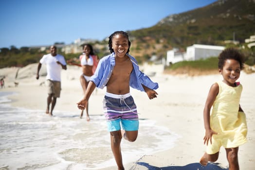 Black family, parents and children or running at beach for adventure, holiday or vacation in summer. African people, face and smile outdoor in nature for break, experience or bonding and relationship.