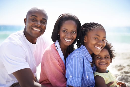 Black family, parents or children and portrait at beach for adventure, holiday or vacation in summer. African people, face or smile outdoor in nature for break, experience or bonding and relationship.