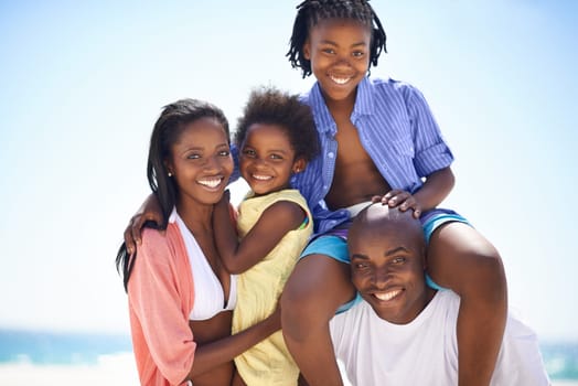 Black family, parents and kids with portrait on beach for adventure, holiday or vacation in summer. African people, face and smile outdoor in nature for break, experience or bonding with relationship.
