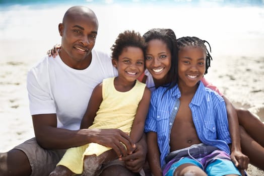Black family, parents or children and portrait at beach for adventure, holiday or vacation in summer. African people, face or smile outdoor in nature for break, experience or bonding and relationship.